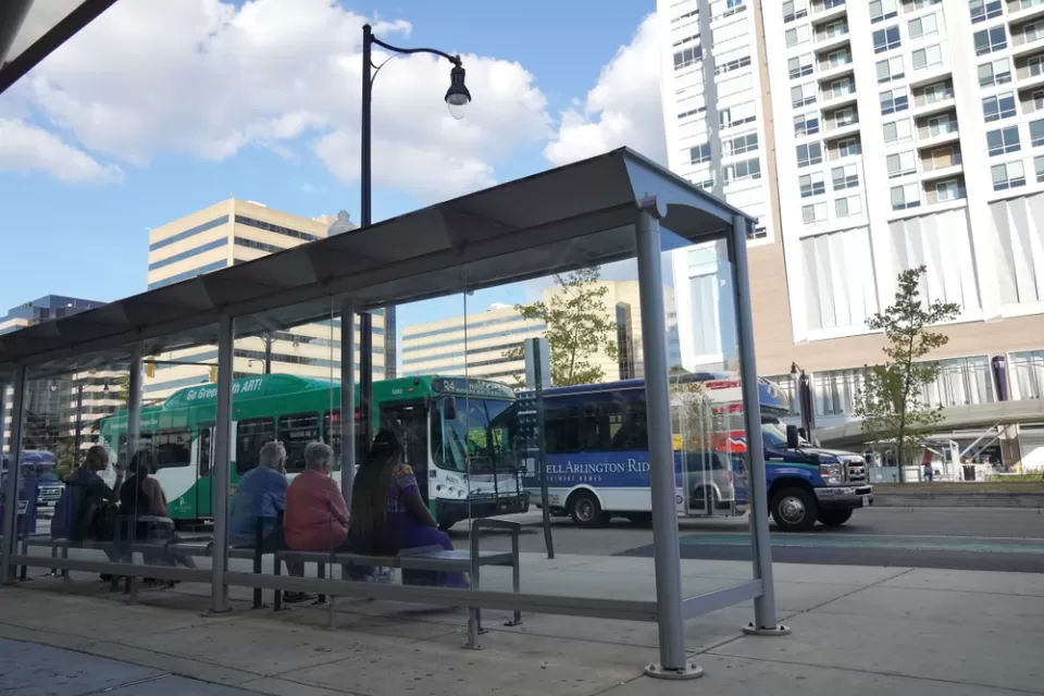 Riders waiting at bus stop in Alexandria, Virginia